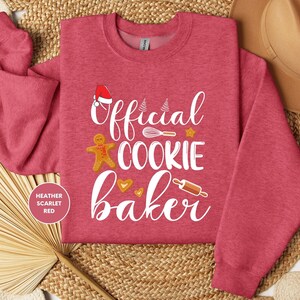 a red shirt that says official cookie baker