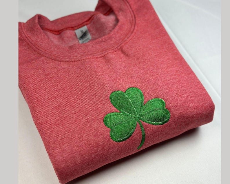 a red shirt with a green clover on it