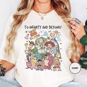 a woman wearing a t - shirt with cartoon characters on it