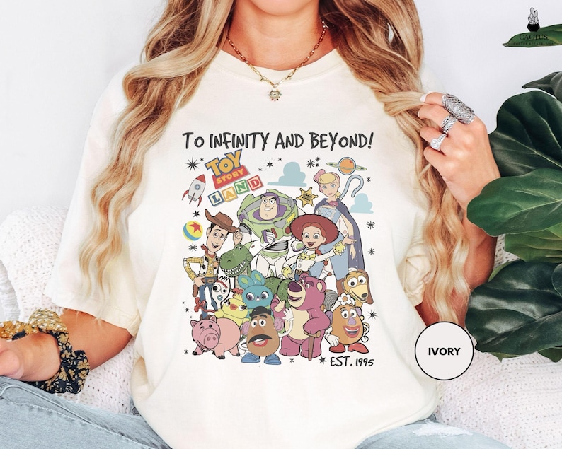 a woman wearing a t - shirt with cartoon characters on it