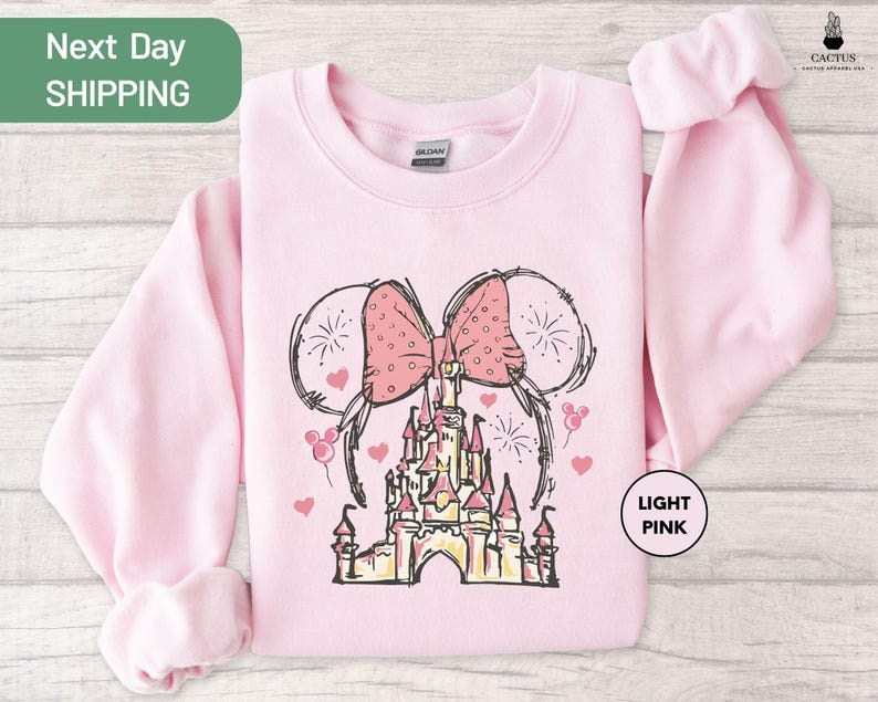 a pink shirt with a picture of a castle on it