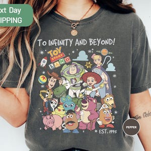 a woman wearing a t - shirt with cartoon characters on it