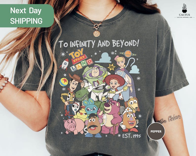 a woman wearing a t - shirt with cartoon characters on it
