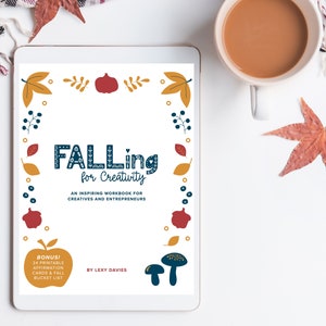 May include: A digital download for a workbook titled "Falling for Creativity: An Inspiring Workbook for Creatives and Entrepreneurs" by Lexy Davies. The cover features a colorful autumn theme with leaves, pumpkins, and mushrooms.