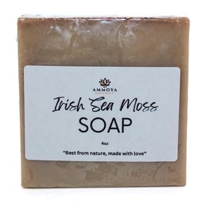 May include: A bar of brown soap with a white label that reads "AMMOYA NATURALS Irish Sea Moss SOAP 4oz "Best from nature, made with love""