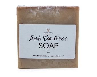 May include: A bar of brown soap with a white label that reads "AMMOYA NATURALS Irish Sea Moss SOAP 4oz "Best from nature, made with love""