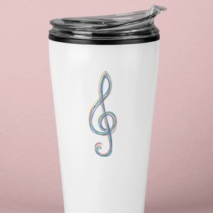 May include: White travel mug with a black lid and a colorful treble clef design. The musical symbol is rendered in a rainbow of colors, including red, blue, and green. The mug is designed to keep beverages hot or cold.