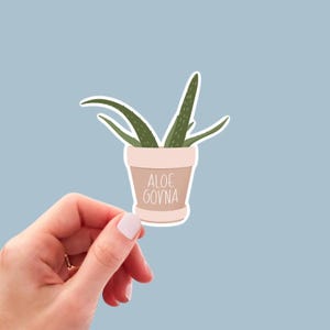 May include: A sticker of a potted aloe plant with the text "ALOE GOVNA" on the pot.
