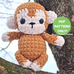 May include: A handmade crochet monkey in shades of brown and cream, with large black eyes and a sweet expression. The plush toy is sitting on a tree branch. The image includes a green circle with the text "PDF PATTERN ONLY!"
