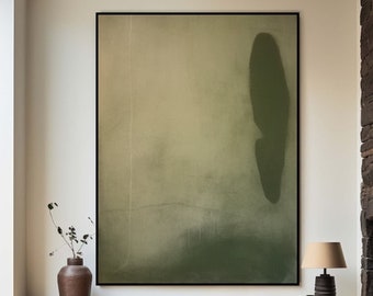 May include: A large abstract painting with a green and beige color scheme. The painting is framed in black and hangs on a white wall above a wooden shelf.