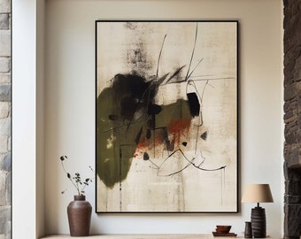May include: Abstract art painting with black, green, and brown brushstrokes on a white canvas. The painting is framed in black and hangs on a white wall.