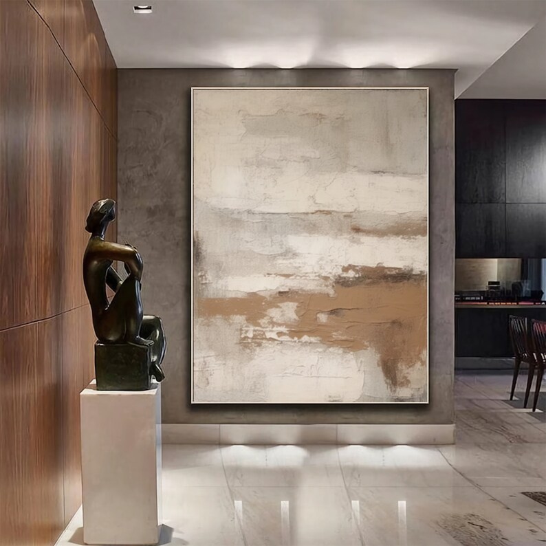 May include: Abstract painting with brown and white hues, featuring a textured, layered effect. The painting is displayed in a modern interior with a sculpture and a wooden wall.