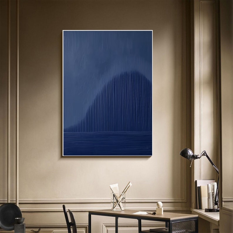 May include: Abstract art print with a dark blue background and a vertical pattern of lines creating a wave-like shape. The print is framed and hanging on a wall.