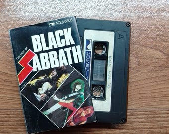 May include: A vintage cassette tape and album cover for "The Best of Black Sabbath." The album cover is black with white text and images of the band members. The cassette tape is black with a white label.