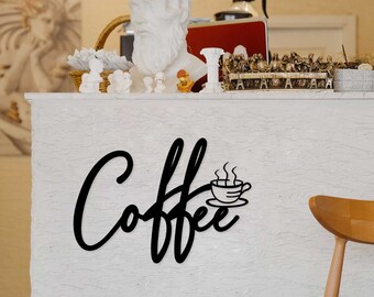 May include: Black metal wall decor with the word "Coffee" in a stylized font and a small coffee cup with steam coming from it.