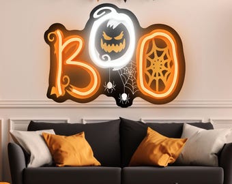 May include: A Halloween-themed wall decoration spelling out "BOO" in orange and white. The "O" features a jack-o'-lantern design and a spider web. Black and orange pennant banners and pumpkins complete the festive scene.