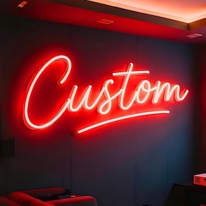 May include: A red neon sign spelling "Custom" in a cursive font, fixed to a dark blue wall. The sign is lit, creating a warm ambience. The room has a red ceiling and a dark blue wall.