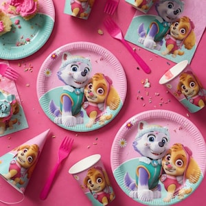 May include: A collection of Paw Patrol themed party supplies, including plates, cups, napkins, forks, and a party hat, all in shades of pink, blue, and white. The plates feature images of Skye and Everest. A cupcake with pink frosting is also visible.
