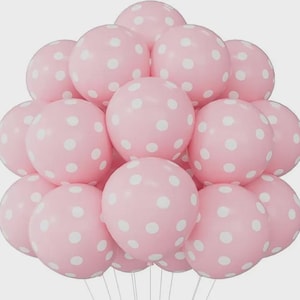 May include: A cluster of round, light pink balloons, each featuring a pattern of white polka dots. The balloons are arranged in a dense, spherical formation, with thin white strings extending downward from the base of the collection.