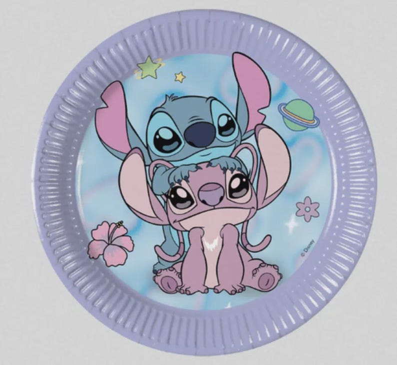 May include: A round paper plate with a light purple rim and a central illustration of the blue character Stitch standing behind the pink character Angel. The background features a light blue sky with small stars, a planet, and pink hibiscus flowers.
