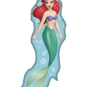 May include: A foil balloon shaped like a mermaid with long red hair, a purple seashell top, and a green scaly tail. The background of the balloon is light blue with white circular bubbles floating around the character's body and tail.