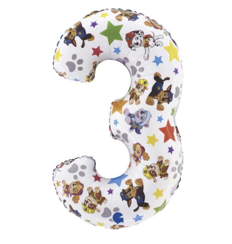 May include: A white number three balloon with a pattern of Paw Patrol characters, paw prints, and colorful stars. The balloon is inflated and ready for a birthday celebration.