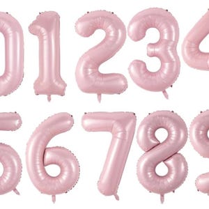May include: A set of ten individual number balloons from zero to nine, each featuring a smooth, matte light pink finish. These inflatable foil balloons are shaped as distinct numerals, designed with a rounded, inflated appearance for display.