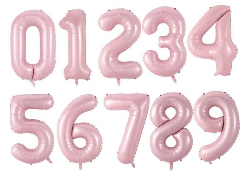 May include: A set of ten individual number balloons from zero to nine, each featuring a smooth, matte light pink finish. These inflatable foil balloons are shaped as distinct numerals, designed with a rounded, inflated appearance for display.