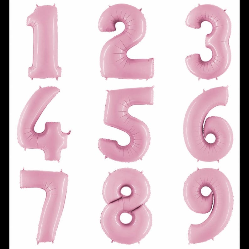 May include: A collection of nine individual light pink foil balloons shaped as the numbers one through nine. Each balloon features a smooth, inflated surface with subtle seam lines along the edges, arranged in a three-by-three grid format.