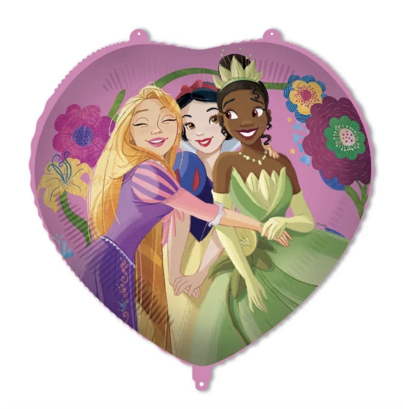May include: A heart-shaped foil balloon featuring a colorful illustration of three animated princesses. The design displays Rapunzel, Snow White, and Tiana standing together against a pink background decorated with large purple and yellow flowers.