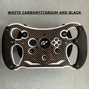 May include: A white, black, and gold racing steering wheel with a carbon fiber design. The steering wheel has buttons, a PlayStation logo, and the text "GT" in the center.