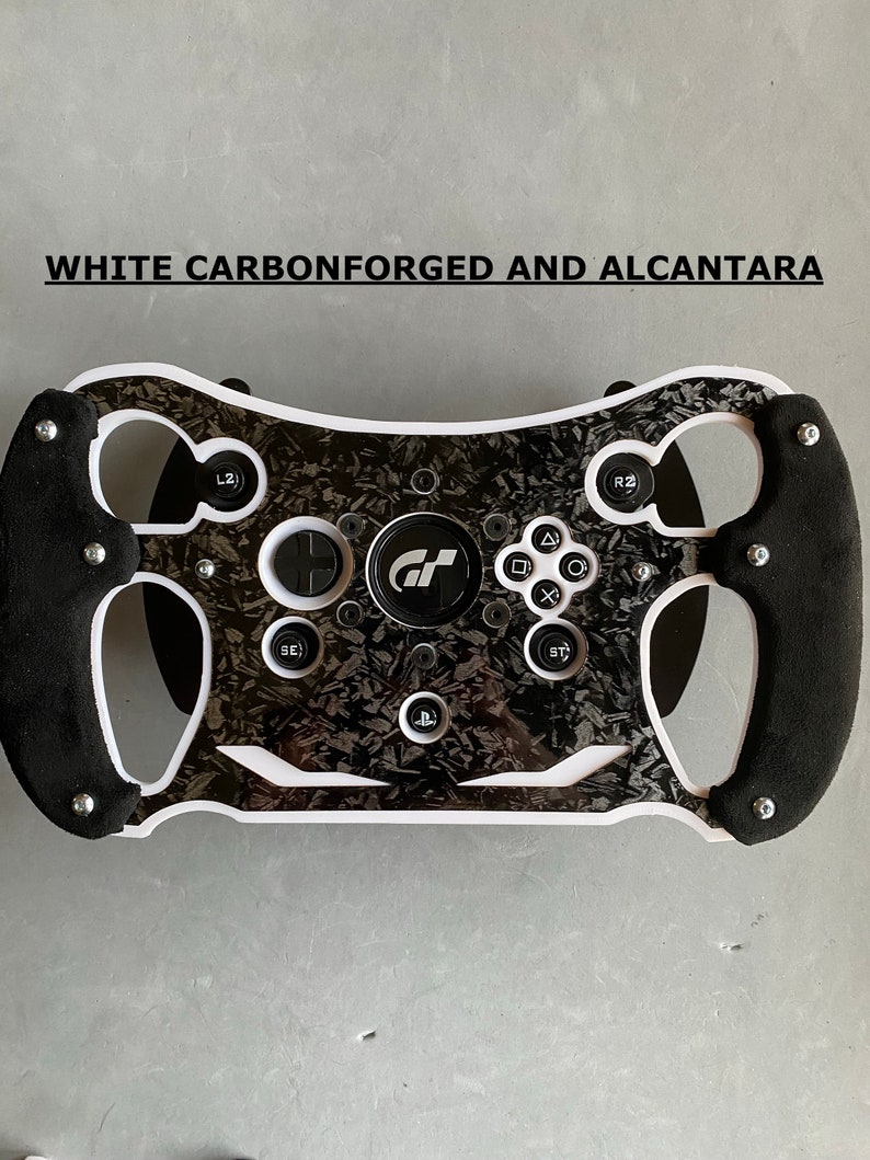 May include: A white racing steering wheel with black accents and a carbon fiber design. The steering wheel has a PlayStation logo and the text "GT" in the center. The text "WHITE CARBONFORGED AND ALCANTARA" is visible at the top of the image.