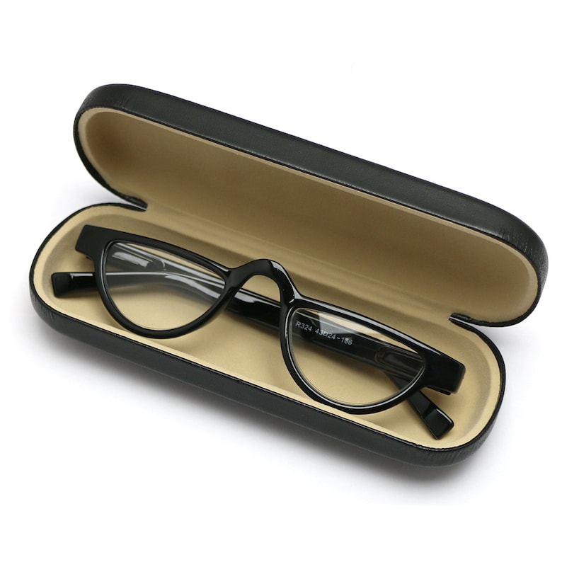 May include: Black eyeglasses with a rounded, cat-eye shape in a black hard case. The case has a beige interior.