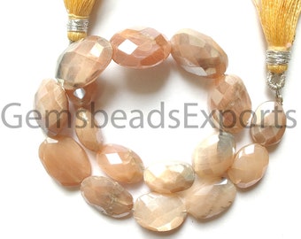 May include: Oval peach-coloured faceted gemstone beads arranged in a circular pattern. The beads have a polished, reflective surface. Two strands of beads are connected to gold tassels with silver accents. The text "GemsbeadsExports" is partially visible.