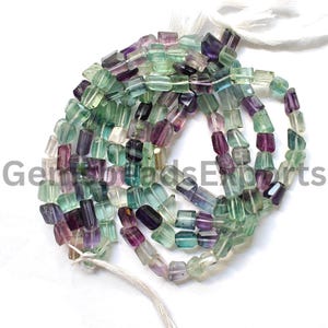 May include: A strand of green, purple, and blue faceted gemstone beads. The beads are rectangular in shape and have a polished finish.