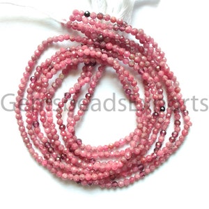 May include: Strands of faceted, pink gemstone beads. The beads are a mix of light and dark pink hues, with a sparkling, polished finish. The beads are strung together, creating a delicate and elegant look. The gemstones are likely used for jewelry making.
