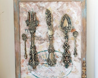 Sculpture décorative de couverts vintage (fourchettes, cuillères, couteau, cuillères à café) sous cadre, idéale pour la cuisine ou comme cadeau. Dimensions : 25 x 30 cm.