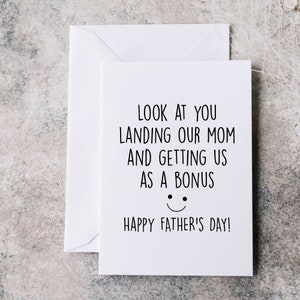 May include: White card with black text that reads "Look at you landing our mom and getting us as a bonus. Happy Father's Day!" with a simple smiley face.