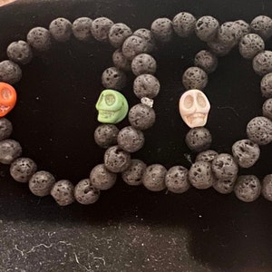 Beaded lava stone and wagnerite skull bracelets with your choice of colored skull.