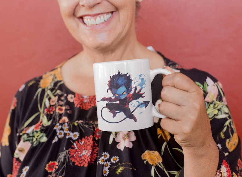 May include: White ceramic mug with a blue and red cartoon character design. The character is a blue-skinned, red-suited, and black-haired figure with a tail. The character is holding a weapon and has a cloud of smoke behind it.