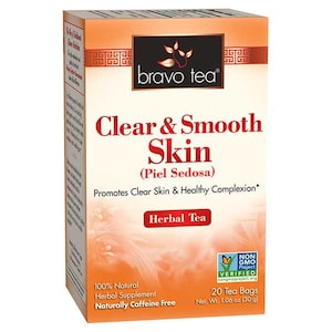 May include: A box of Bravo Tea Clear & Smooth Skin herbal tea. The box is orange with a picture of a flower. The text on the box says "Promotes Clear Skin & Healthy Complexion." The box contains 20 tea bags and is naturally caffeine free.