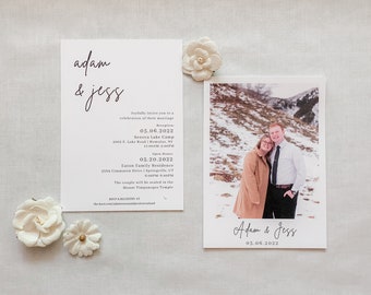 May include: Wedding invitation with a white background and black text. The invitation includes the names "adam & jess" and the wedding date "05.06.2022". The invitation also includes the ceremony and reception details. A photo of the couple is included on a separate card with the names "Adam & Jess" and the wedding date "05.06.2022".