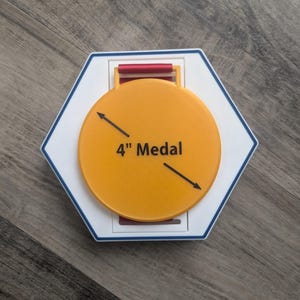 May include: An orange 4-inch medal with the text "4" Medal" is centered on a white and blue hexagonal base. A red ribbon holder is at the top. The medal is on a wooden surface.
