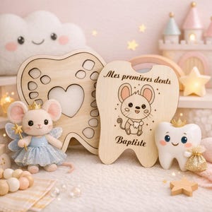 May include: A wooden tooth-shaped keepsake box with the text "Mes premi&egrave;res dents" and a cartoon mouse illustration. A plush mouse wearing a crown and holding a wand is next to the box. A smiling tooth figurine with a crown and a small bag is also present.