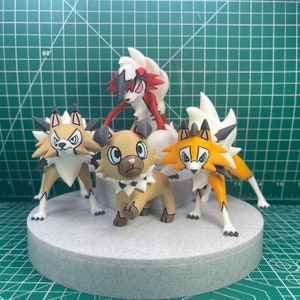 May include: Four Pokemon figures, including a brown and white figure with a red and black figure on top, a brown and white figure with a red and black figure on top, a brown and white figure with a red and black figure on top, and a brown and white figure with a red and black figure on top.