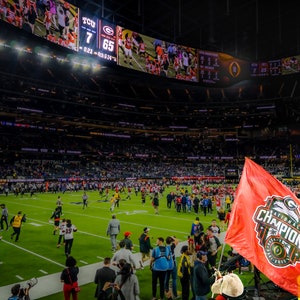 2023 UGA National Champions - Hairy Dawg with Natty Flag as game ends