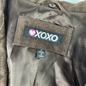 May include: Brown suede jacket with a black label that says "XOXO" with a pink heart. The label also says "Made in China" and "S".
