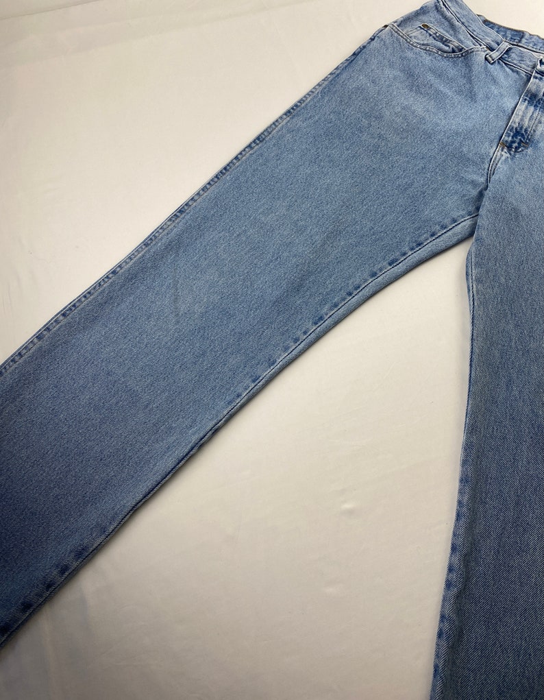 May include: A pair of light blue denim jeans with a straight leg fit.