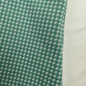 May include: Green and white fabric with a small checkered pattern.