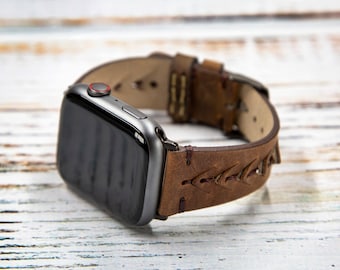 May include: A brown leather watch band with a braided design. The band is attached to a silver smartwatch with a black screen.